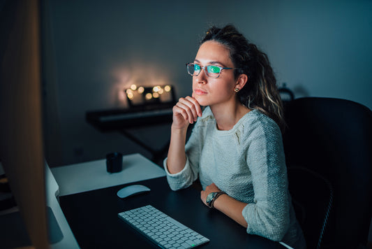 Woman wearing glasses, working