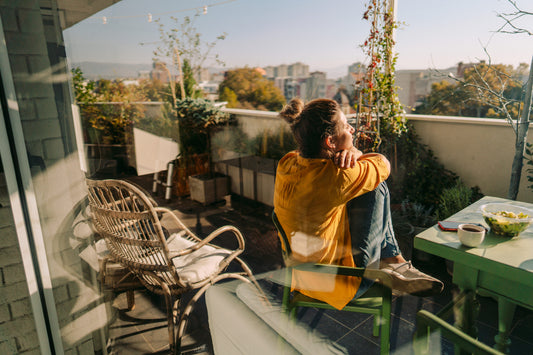 Woman on terrace, drinking coffee