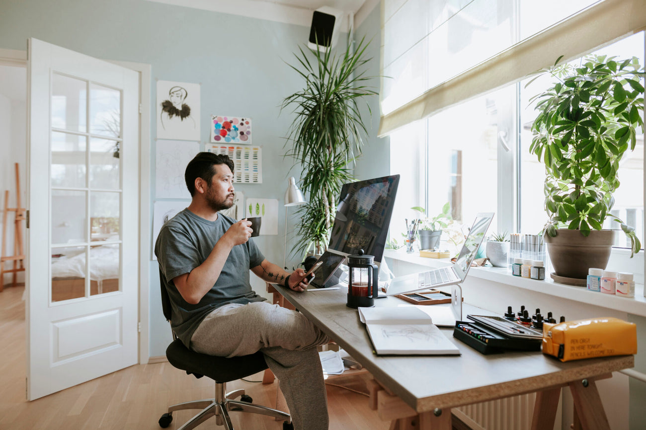 Man sitting at home office, drinking coffee